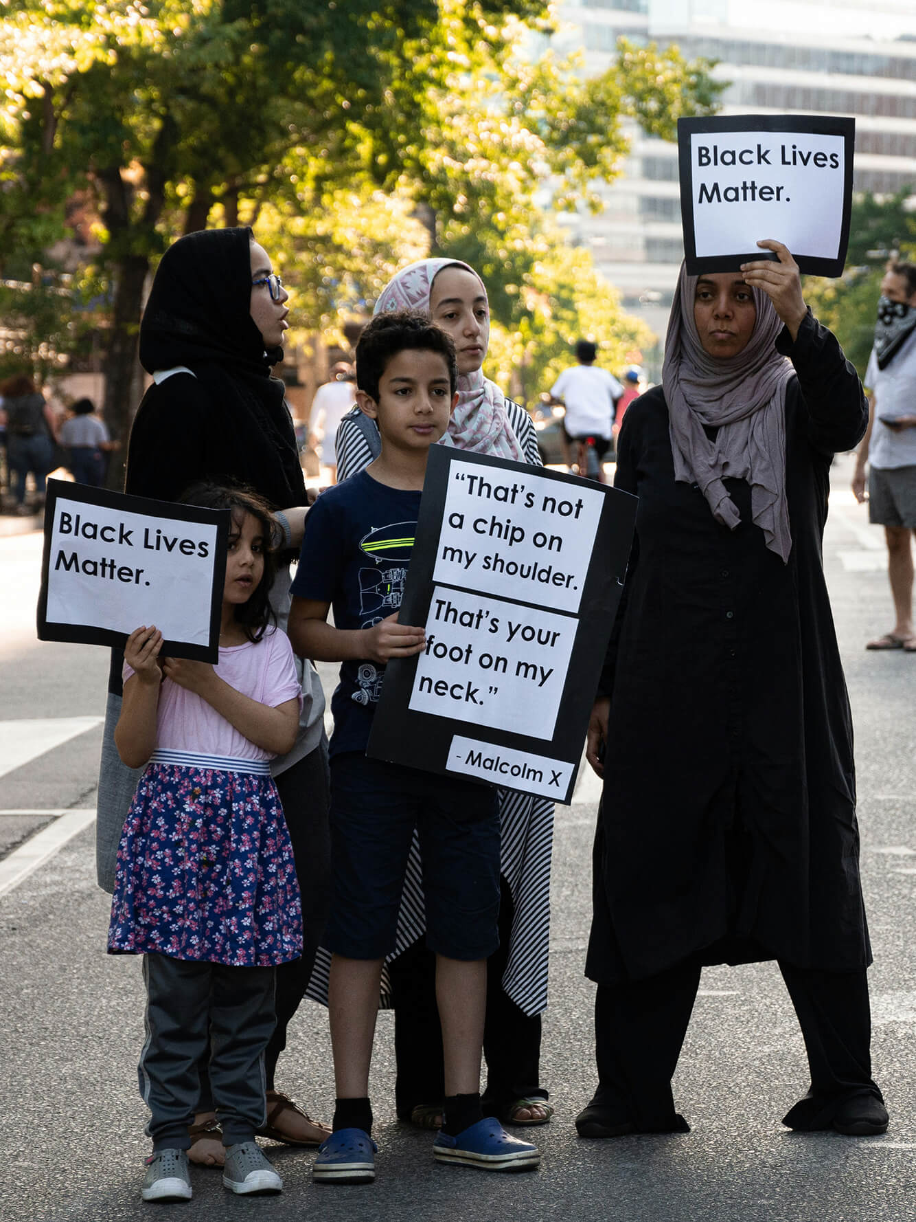 Activists at a rally holding signs